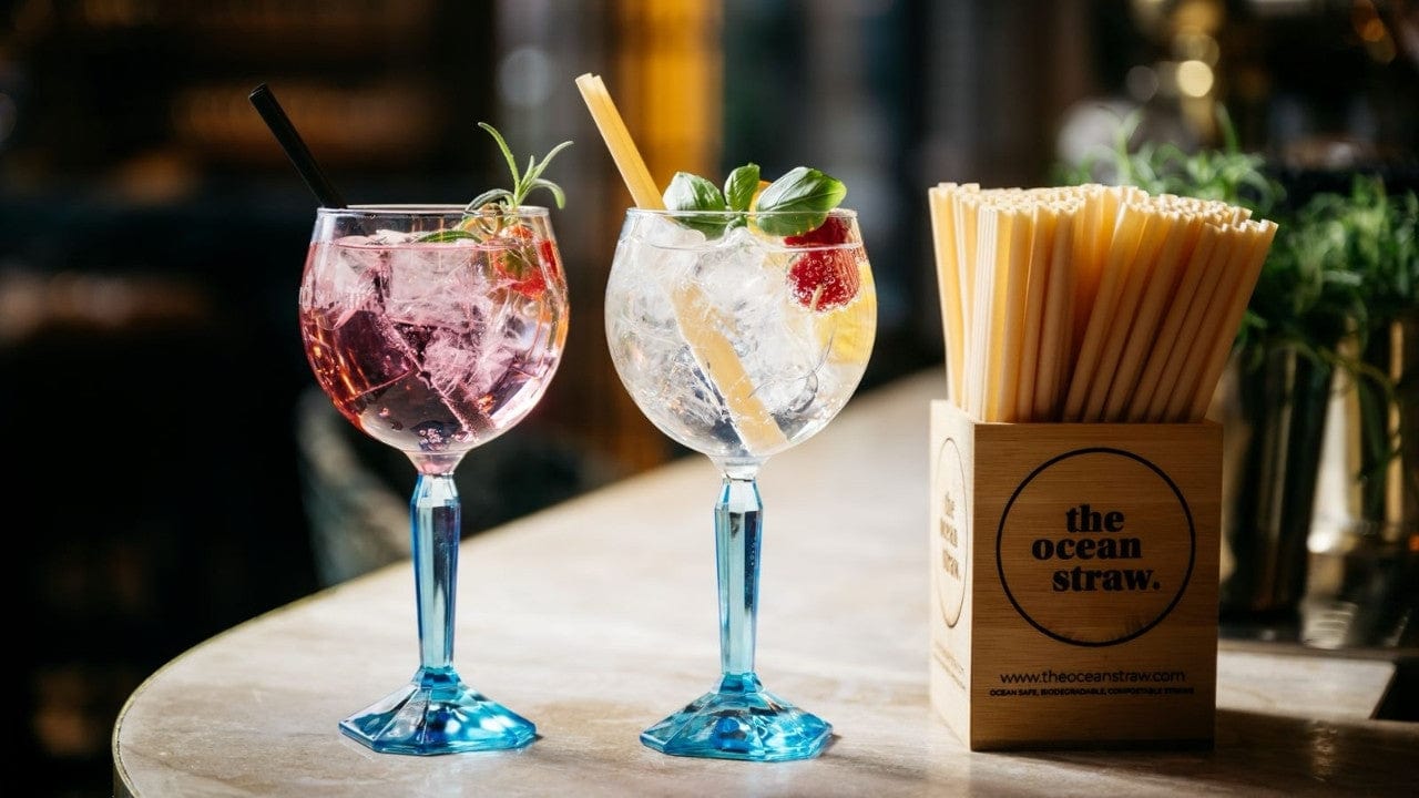 Two cocktails served in The Ocean Cup with The Ocean Straw, on a bar table – showcasing sustainable drinkware for the HoReCa industry